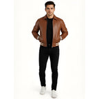 Man wearing a brown leather jacket with white trim on a white background