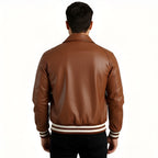 Brown leather jacket worn by a person on a white background
