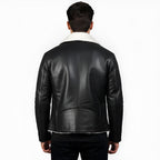 Black leather jacket with white lining worn by a person on a white background