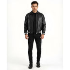 Man wearing a black leather jacket with white trim on a white background