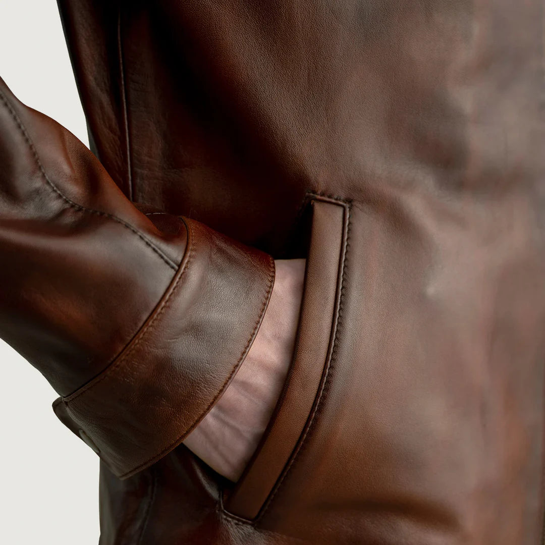 Close-up of a brown leather jacket with a blurred background