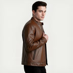 Man wearing a brown leather jacket on a light gray background