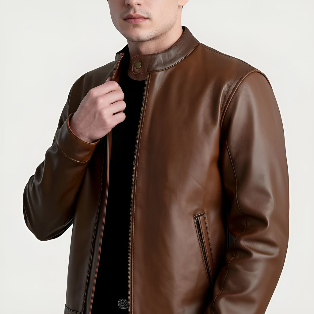 Brown leather jacket worn by a person on a light gray background