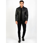 Man wearing a black leather jacket and black pants on a white background