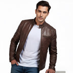Man wearing a brown leather jacket over a white shirt on a white background
