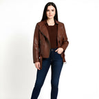 Woman wearing a brown leather jacket and blue jeans on a white background