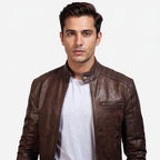 Man wearing a brown leather jacket on a white background