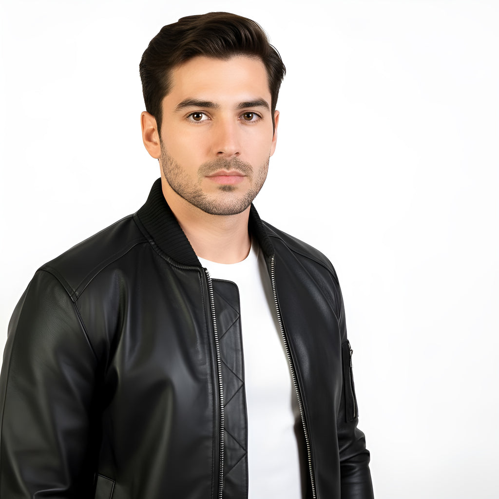Man wearing a black leather jacket over a white shirt on a white background
