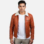 Man wearing a brown leather jacket with white fur lining on a white background