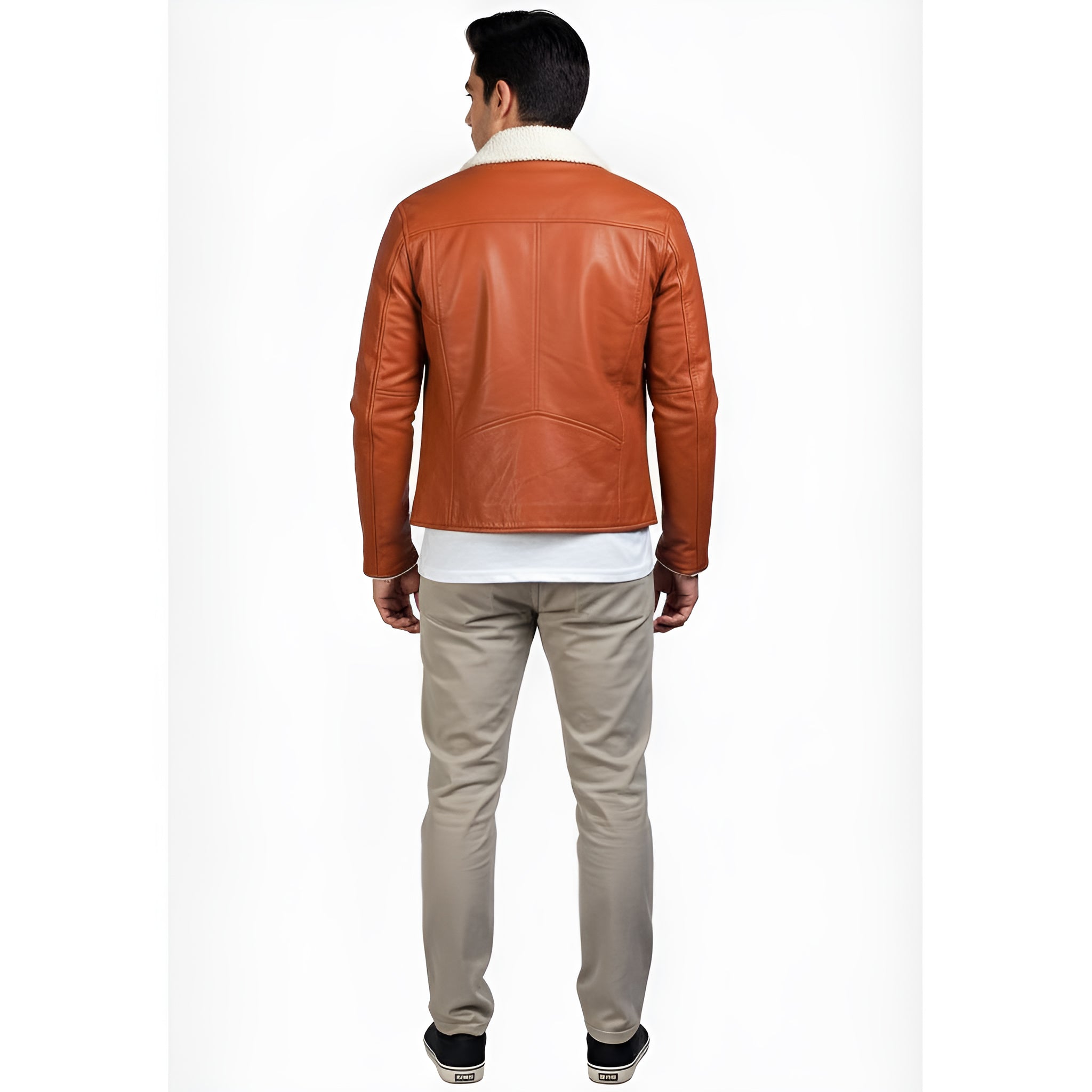 Man wearing a brown leather jacket and beige pants on a white background