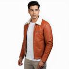 Man wearing a brown leather jacket with white fur lining on a white background