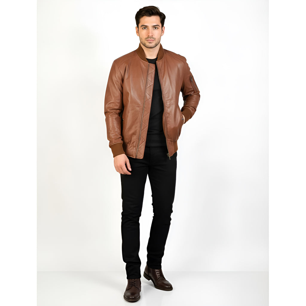 Man wearing a brown leather jacket and black pants on a white background