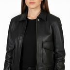 Black leather jacket worn by a person on a white background