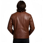 Brown leather jacket worn by a person on a white background
