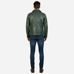 Man wearing a green leather jacket and blue jeans on a white background