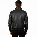Black leather jacket worn by a person on a white background