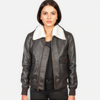 Woman wearing a dark leather jacket with white fur lining on a plain background