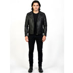 Man wearing a black leather jacket and black pants on a white background