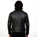 Black leather jacket worn by a person on a white background